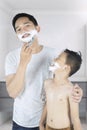 Father and son use shaving cream Royalty Free Stock Photo