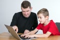 Father and son using computer together Royalty Free Stock Photo