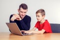 Father and son using computer together Royalty Free Stock Photo