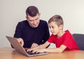 Father and son using computer together Royalty Free Stock Photo