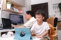 Father and son using computers at home, Coronavirus pandemic prevention, Businessman working from home, while in quarantine during