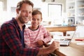 Father and son using laptop computer at home Royalty Free Stock Photo