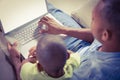 Father and son using laptop on the couch Royalty Free Stock Photo