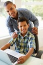 Father And Son Using Laptop At Home Royalty Free Stock Photo