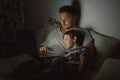 Father and son using laptop by night at home on the bedroom Royalty Free Stock Photo