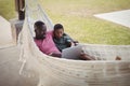 Father and son using laptop while relaxing on hammock Royalty Free Stock Photo