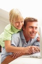 Father And Son Using Laptop Sitting On Sofa Royalty Free Stock Photo