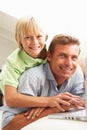 Father And Son Using Laptop Sitting On Sofa Royalty Free Stock Photo