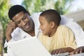 Father And Son Using Laptop Together Royalty Free Stock Photo