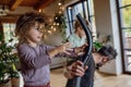 Father and son vacuuming girl& x27;s hair with vacuum cleaner. Father with kids cleaning house, helping with house chores