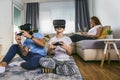 Father and son in virtual reality headsets playing with joysticks at home Royalty Free Stock Photo