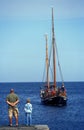 Father and son waiting for a boat in Svaneke harbor on Bornholm island