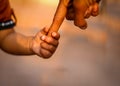 father and son walk along holding hands,the parent holding the child hand with a happy background,a parent holds the Royalty Free Stock Photo