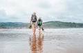 Father with son walk barefoot on the sand ocean beach Royalty Free Stock Photo