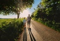 Father and son walk on sunset road Royalty Free Stock Photo