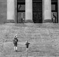 Black and white image of people walking up the steps of the Washington State Capitol building