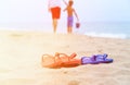 Father and son walking at beach, flip flops on sand Royalty Free Stock Photo