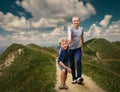 Father and Son walking on the highmountain footpath;