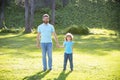 father and son walking in park. happy family value. childhood and parenthood.