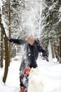 Father and son walking in snowy forest with his beagle dog in pine forest. Family walking with pets and winter outfit Royalty Free Stock Photo