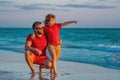Father and son walking together on the beach. Fatherhood family concept. Travel on sea with father. Relax on beach