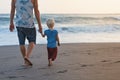 Father and son walks on sunset ocean beach Royalty Free Stock Photo