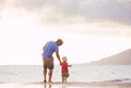 Father and son wallking on the beach