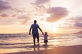 Father and son wallking on the beach