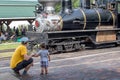 Father and son watch A vintage steam engine