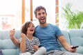 Father and son watching television on sofa Royalty Free Stock Photo