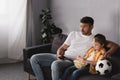 Father and son watching tv with Royalty Free Stock Photo