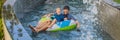 Father and son on a water slide in the water park BANNER, LONG FORMAT Royalty Free Stock Photo