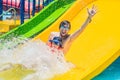 Father and son on a water slide in the water park Royalty Free Stock Photo