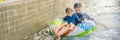 Father and son on a water slide in the water park BANNER, LONG FORMAT Royalty Free Stock Photo