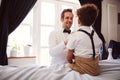 Father And Son Wearing Matching Outfits Getting Ready For Wedding At Home