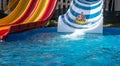 Father and son on wide striped water slide Royalty Free Stock Photo