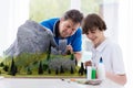 Father and son work on model building project