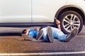 Father and son working under broken car together Royalty Free Stock Photo