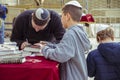 Father and son writing on a paper pray and wish at the western w