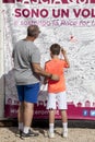 Father and son writing on a wall solidarity, breast female cancer