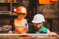 Father and sons are are building the furniture at home. Little construction worker. Father shows his little son how to Royalty Free Stock Photo