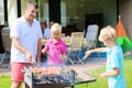Father with sons grilling meat in the garden Royalty Free Stock Photo