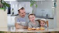 Father and sons with menorah celebrate Hanukkah