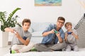 Father and sons playing video games Royalty Free Stock Photo