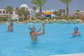 Father and sons playing water in tropical resort pool Royalty Free Stock Photo