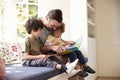 Father And Sons Reading Story At Home Together Royalty Free Stock Photo