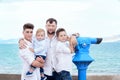 Father and sons at sea. Family on viewing platform near the Coin