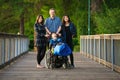 Father standing with biracial children on wooden bridge, special needs Royalty Free Stock Photo