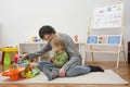 Father and sweet little child boy having fun playing with cars and colorful toys, on the floor, at home. Beautiful family moment, Royalty Free Stock Photo