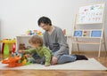 Father and sweet little child boy having fun playing with cars and colorful toys, on the floor, at home. Beautiful family moment, Royalty Free Stock Photo